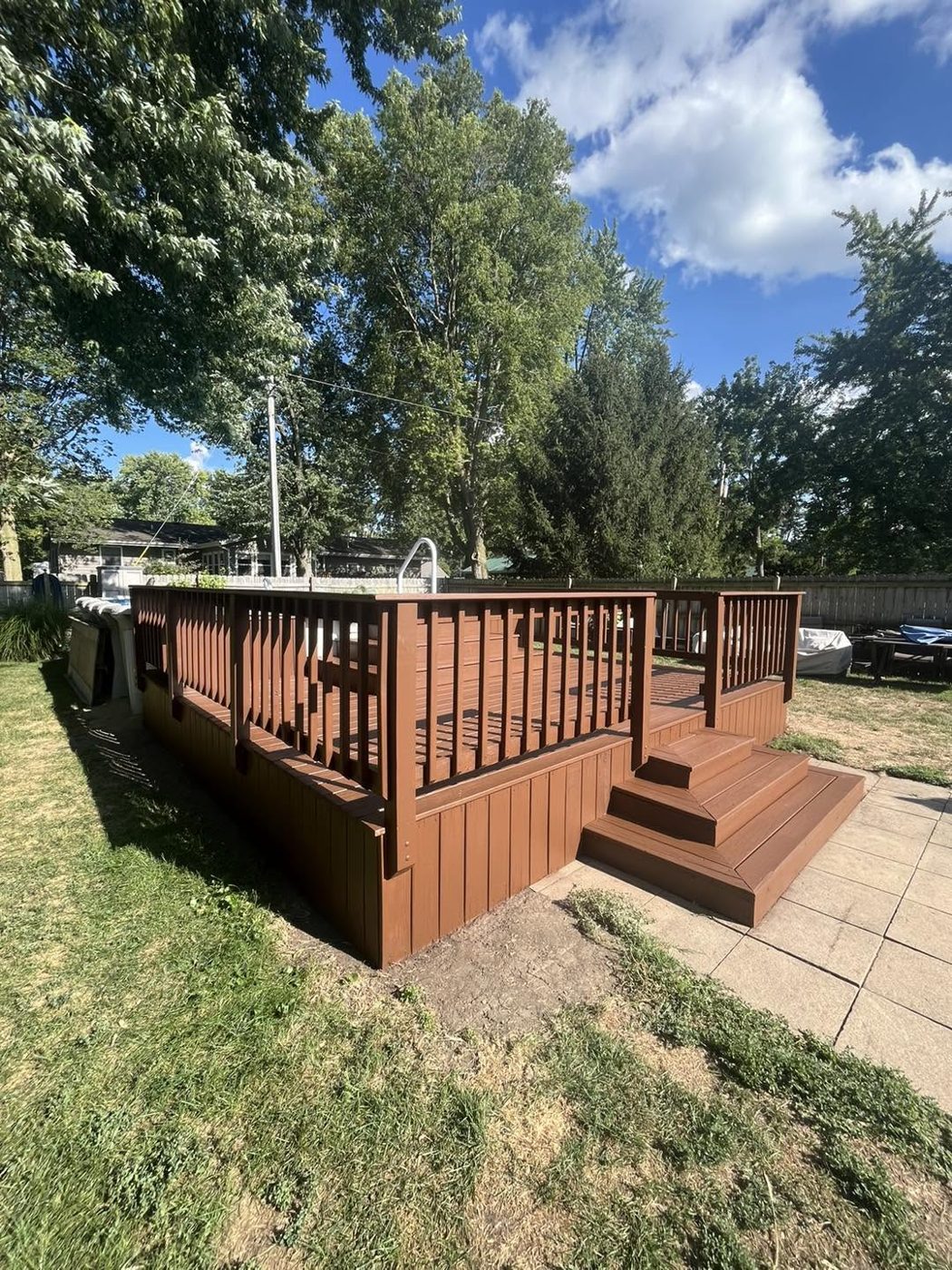 Backyard deck restored and stained in a rich cedar tone