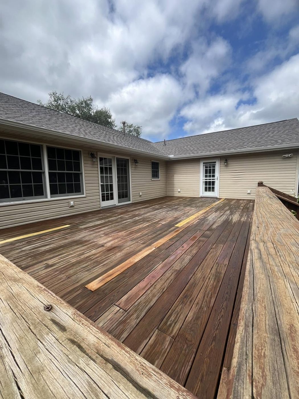 Deck with new replacement boards before staining